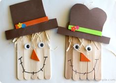 two scarecrows made out of popsicle sticks