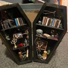 two black shelves with books and other items on them in the shape of hexagons