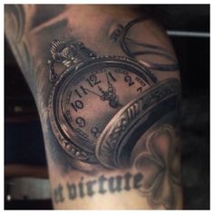 an image of a man with tattoos on his arm that has a pocket watch tattoo on it