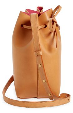 A coated, matte-patent lining creates colorful contrast on this bucket bag made from vegetable-tanned Italian leather that develops a rich patina over time. Drawstring closure Adjustable push-stud strap Natural colorways will darken over time Patent-leather lining Leather Made in Italy Designer Handbags Mansur Gavriel, Leather Bucket Bag, Leather Bucket, Italian Leather, Designer Handbags, Bag Making, Bucket Bag, Patent Leather, Patina