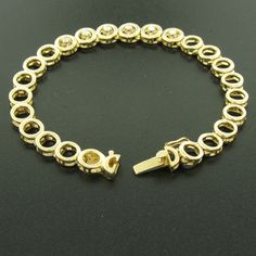 Here we have a beautiful 7 inch gold bracelet with diamonds. The bracelet is solid 14k yellow gold and features 24 round links. The 6 center links each feature a round brilliant cut diamond prong set in the middle. The other 18 links are simple, round, open links. The bracelet is secured with a box-like clasp and tight safety latch. A simple yet beautiful gold and diamond bracelet. Enjoy! Material: 14k Solid Yellow Gold Weight: 17.1 Grams Stone(s): (6) Natural Genuine Diamonds - Round Brilliant Gold Tennis Bracelet With Brilliant Cut, Gold Jewelry With Prong Setting And Oval Link, Cubic Zirconia Diamond Bracelet With Solid Link, Fine Jewelry Tennis Bracelet With Solid Link Construction, Round Gold Bracelet With Solid Link Construction For Anniversary, Round Gold Bracelet With Solid Link For Anniversary, Round Gold Anniversary Bracelet With Solid Link, Anniversary Gold Bracelet With Solid Link, Gold And Diamond Bracelet