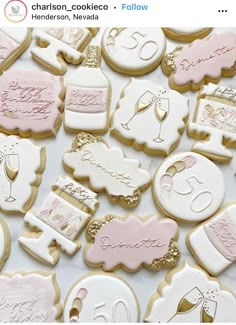 some cookies that are on top of a white tablecloth with pink and gold trimmings