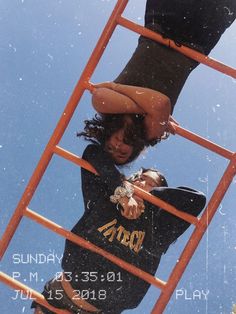 a woman standing on top of a red ladder