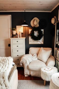 a living room with a white couch and some hats on top of the headboard