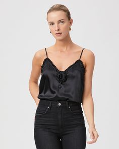 This elevated cami is made from 100% silk satin. The Reina features a flattering v-neck line with ruffle detailing, adjustable straps, and a removable rosette detail in the middle, perfect for the modern romantic. | Reina Cami Rosette - Black Silk Satin | Size XS Chic Black Satin Camisole, Black Silk Camisole Chic Style, Chic Black Silk Camisole, Chic Silk Camisole With Adjustable Straps, Black Silk Camisole For Spring, Silk Satin Finish Camisole For Spring, Chic Satin Camisole, Chic Satin Camisole For Spring, Chic Spring Camisole With Satin Finish