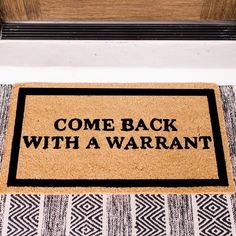 a welcome mat with the words come back with a warrant on it next to a door