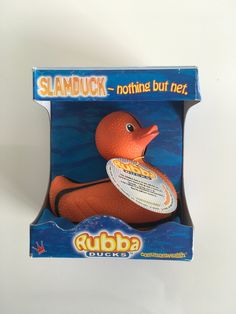 an orange rubber duck with a frisbee in it's mouth is shown