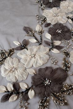 some flowers and pearls on a white cloth