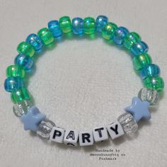 Holographic Blue And Holographic Green Yellow Pony Bead Bracelet "Party" With Clear Glittery And Solid Blue Star Bead Accents Double Stranded Elastic Kandi Bracelet Perfect For Emo, Scene, Y2k, Rave, Festival, Goth, Pastel Goth, Egirl, Gamer, Lgbt Pride Aesthetics. Elastic Bracelet Has Fair Stretch. Model Wrist 6.5" Model Hand 7.5" Please Check Measurements For Both. Please Do Not Exceed 8" Width, Elastic Will Break More Sizes Will Be Included Soon. Stock And Supplies Are Limited. Original Handm Trendy Beaded Bracelets With Tiny Beads For Parties, Trendy Turquoise Bracelets For Party, Green Stretch Bracelet With Colorful Beads For Party, Party Beaded Bracelets With Letter Beads And Round Beads, Blue Tiny Beads For Party, Trendy Blue Beaded Bracelets For Party, Party Bracelets With Colorful Round Beads, Party Adjustable Beaded Friendship Bracelets, Green Round Beads Stretch Bracelet For Party