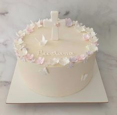 a cake decorated with flowers and a cross