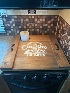 a wooden cutting board sitting on top of an oven