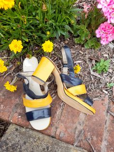 The most epic pair of platforms.. coming your way today Check out these beauties! 70's DUNLOP 'liftees". Chunky platform slingback sandals in navy and mustard yellow vinyl... (I think it's vinyl rather than leather but can't be 100% sure). Adjustable ankle strap. Yellow covered block heel and platform sole. Made in Honk Kong💛💙 These are just FAB Looking at the soles they look virtually unworn. They appear intact. Only issue I can see is that the original glue used has now darkened so there is Slingback Shoes, Slingback Sandals, 70s Vintage, Chunky Platform, Slingback Sandal, Vintage Shoes, Strappy Sandals, Womens Heels, Mustard Yellow