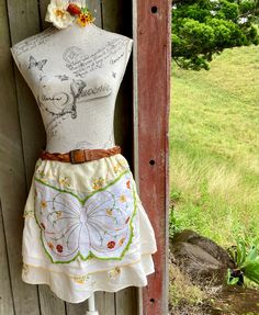 a mannequin wearing a skirt with flowers on it