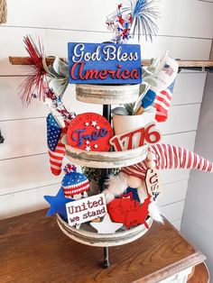 a patriotic hat tree with red, white and blue decorations on it's top