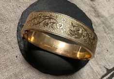 "Lovely Gold filled engraved rose bangle.  Condition is very good for its age, any slight wear commensurate with age, clasp works-images show the elegant design and nice condition, it is signed B Co.- 1/20 12K.  Size inner diameter approx 6 3/4\", width 5/8\" or 16mm, safety chain for added security, wt.- 24.3 grams.  Great design and easy to wear." Vintage 14k Stamped Round Bangle, Antique Round Cuff Bracelet For Wedding, Victorian Etched Cuff Bracelet For Wedding, Victorian Engraved Gold Bracelet, Antique Etched Bangle For Wedding, Antique Engraved Gold Bracelet, Vintage 14k Stamped Bangle For Weddings, Antique Etched Wedding Bangle, Antique Etched Bracelets For Wedding