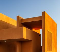 an orange building with two doors on each side