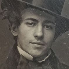 a man in a top hat and bow tie is looking at the camera with an intense look on his face