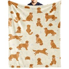 a person holding up a blanket with dogs on it