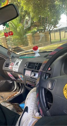 the interior of a car with various stickers on the dash board and steering wheel