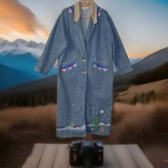 This Unique Trench Coat Is A Must-Have For Any Fashion-Forward Woman. The Coat Features A Vintage American Profile Dungarees Design With A Southwestern Art Pattern That Is Sure To Make A Statement. The Long Coat Is Made From Denim Fabric And Has A Corduroy Collar And Cuffs For Added Style. The Coat Is Perfect For Any Occasion, Whether It's For Travel, Parties, Casual Wear, Or Work. It Has A Button Closure And Is Machine Washable For Easy Care. The Coat Is Blue In Color And Has A Size Large Fit. This 90s Vintage Coat Is A Great Addition To Any Wardrobe And Is Sure To Turn Heads. * Item May Have One Or 2 Tiny Stains Hardly Noticeable Check Pics Jean Trench Coat, Southwestern Art, Unisex Jacket, Kids Coats, Work It, Vintage Coat, Dungarees, 90s Vintage, Denim Fabric