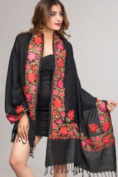 "Our Taj Embroidered Wool Shawl features exquisite embroidery on a soft 80% wool 20% polyester blend. This stunning embroidered shawl showcases the intricate embroidery traditions of Northern India in rich earthen tones on a black base. Sevya offers a unique collection of embroidered Indian shawls, in a range of patterns and colors to suit any occasion. Dimensions: 28\" x 72\"" Elegant Black Dupatta For Winter, Pashmina Shawl With Floral Embroidery, Black Pashmina Shawl For Festive Occasions, Embroidered Black Dupatta In Traditional Drape, Black Embroidered Dupatta In Traditional Drape, Black Embroidered Dupatta With Traditional Drape, Traditional Embroidered Winter Scarves, Elegant Embroidered Multicolor Pashmina Shawl, Elegant Embroidered Fall Shawl