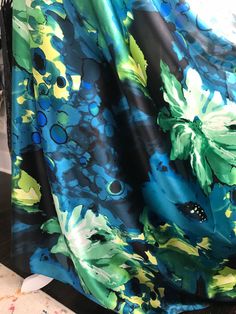 "\"Floral Fusion\": Blue, green, and yellow printed silk charmeuse. (302) Sold by the yard ($41). 16mm 45 inch width. Dry cleaning recommended. 100% silk." Patterned Printed Silk Scarf, Green Silk Scarf For Party, Fabric Shops, Sea Coral, Thread Spools, Yellow Print, Silk Charmeuse, Silk Organza, Gorgeous Fabrics