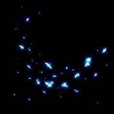 a group of birds flying in the night sky with bright lights on it's wings