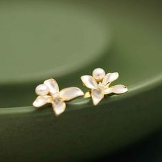 Why We Made This Our White Lilac Flower Earring Studs are a perfect blend of simplicity and elegance. These tiny yet elegant earrings capture the essence of purity and innocence, symbolized by the white lilac flower. The delicate design, combined with the symbolic meaning of the white lilac, makes these earrings a thoughtful and stylish accessory. The freshwater pearl and sparkling zircon add a touch of sophistication, making them suitable for both casual and formal occasions. Product Details MA Elegant White Flower Earrings, White Flower Drop Earrings For Formal Occasions, Elegant White Pearl Earrings With Flower Charm, White Drop Flower Earrings For Formal Occasions, White Classic Flower Earrings For Anniversary, White Feminine Flower Earrings For Formal Occasions, Classic White Flower Earrings For Anniversary, Elegant White Petal Flower Earrings, Delicate Pearl White Flower Earrings