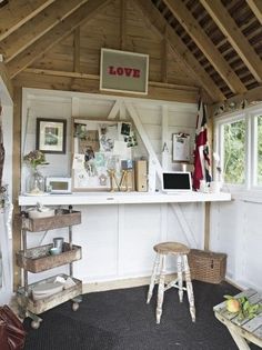 the inside of a small room with lots of clutter and decor on it's walls