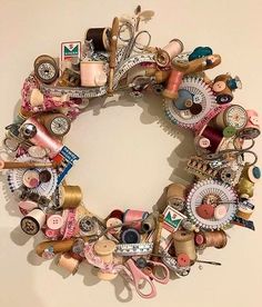 a wreath made out of various sewing items