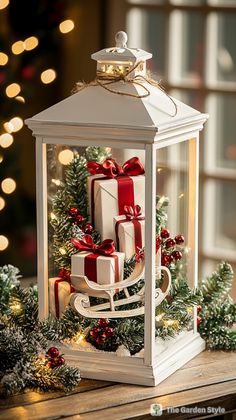 a lantern with presents wrapped in red and white