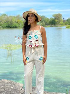 This modern style jumpsuit with beautiful traditional embroidered flowers is the perfect look for this season. It is a slim fitting romper with elastic on the back, buttons in the front and a tie around the waist. It also has embroidered pockets on each side. This jumpsuit is hand embroidered in Silk Thread with love for you by Mexican Artisans. Embroidered Cotton Jumpsuits And Rompers For Spring, Casual Embroidered Jumpsuits And Rompers For Spring, Cotton Jumpsuits And Rompers For Summer Festivals, Spring Festival Jumpsuits And Rompers, Embroidered Cotton Jumpsuits And Rompers For Summer, Embroidered Fitted Sleeveless Jumpsuits And Rompers, Fitted Cotton Jumpsuit For Beach, Sleeveless Embroidered Jumpsuits And Rompers For Summer, Embroidered Fitted Jumpsuits And Rompers For Spring