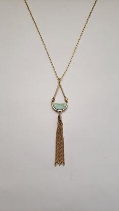 "This necklace has a beautiful geometric pattern with a gorgeous color scheme, making it a lovely gift for your loved one. It features a gold-tone pendant with a blue piece inserted within and a gold tassel that all dangle from a 30\" chain. It is simple yet elegant in design and will soon be a go-to favorite necklace. Welcome to Recycled Finery!  I repurpose old jewelry, coins, beads, vintage buttons, watch parts, and charms into new jewelry.  My ever-growing collection of these materials comes from estate sales, rummage sales, antique and thrift stores, and family and friends' collections they no longer need or want. I have fun putting these new pieces together and hope that you will find them fun to wear and as unique gifts for your loved ones.  Thank you for your interest and purchase! Gold Tassel Necklace, Minimalist Necklace Gold, Anniversary Gift For Wife, Watch Parts, Necklace Minimalist, Anniversary Gifts For Wife, Geometric Necklace, Old Jewelry, Birthday Gift For Her