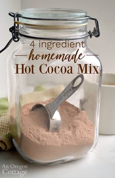 homemade hot cocoa mix in a glass jar with a measuring spoon on the side and text overlay that reads 4 ingredient homemade hot cocoa mix