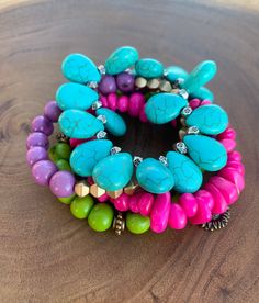 Bold, funky, and full of color and happiness, this stunning tagua and acai seed bracelet is a must-have piece for your jewelry collection. The eye-catching combination of turquoise, lavender, purple, hot pink and green will give your outfit a splash of color.  To make this eye-popping multi strand bracelet I used tagua chips, acai seeds from Colombia, glass beads and antique bronze beads, and turquoise hoplite in teardrop shape.   Pair this fantastic bracelet with any of our 24k gold plated earr Stackable Turquoise Jewelry For Festivals, Stackable Bohemian Turquoise Beaded Bracelets, Bohemian Turquoise Stackable Beaded Bracelets, Bohemian Stackable Beaded Bracelets In Turquoise, Spiritual Stackable Turquoise Stretch Bracelet, Bohemian Stretch Bracelet With Colorful Turquoise Beads, Bohemian Stretch Bracelet With Colorful Beads In Turquoise, Bohemian Turquoise Stretch Bracelet With Colorful Beads, Turquoise Stretch Bracelet With Colorful Beads As A Gift