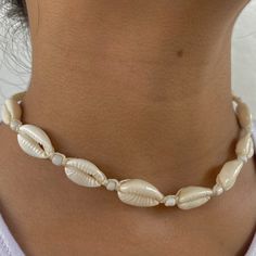 🐚 Embrace Bohemian Elegance! Introducing our Chic Cowrie Shell Choker Necklace, a stunning piece meticulously handcrafted to bring a touch of bohemian elegance to your style! This necklace is a true reflection of a love for the beach, symbolizing adventure, freedom, and a deep connection with nature. 🌊 Inspired by the Beauty of the Ocean: Crafted with a passion for the serene beauty of the ocean and the elegance of natural elements, this necklace is a celebration of adventure, tranquility, and the timeless beauty of nature. It's a versatile accessory for those who appreciate chic elegance and the calming ambiance of the beach. 🌟 Unique & Trendy Design: With its distinctive cowrie shells and choker style, this necklace is a trendy and unique addition to any outfit. Whether you're enjoyin Handmade Elegant Beaded Necklaces For Vacation, Elegant Handmade Beaded Necklaces For Vacation, White Handmade Strand Jewelry, Handmade White Strand Jewelry, Bohemian Beaded Pearl White Necklaces, Bohemian Beaded Pearl White Necklace, Bohemian Cream Jewelry For Jewelry Making, Bohemian White Jewelry For Summer, White Necklace For Festivals