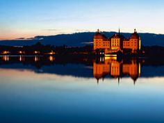 a large building sitting on top of a lake