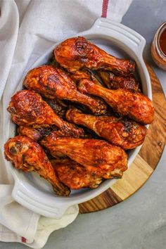 chicken wings in a bowl with sauce on the side