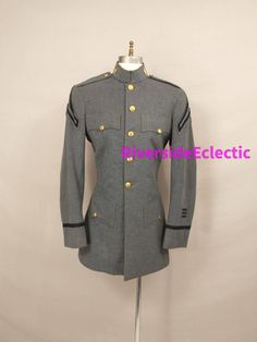 "Classic formal style in a long dress wool jacket. Valley Forge Military Academy on the buttons. Quality construction and nice detail. Made in USA, nice piece for collection, theater, steampunk, reenactment or costume. Faux front pockets. Condition is good but with some issues. Slight stiffness to wool, wear at wrists and back of collar, a couple discreet moth holes (at armpits and back of neck), light staining on lining. Size unmarked, shown on a 6 women's mannequin - best to go by measurements Formal Fitted Blazer With Epaulettes, Fitted Fall Blazer With Epaulettes, Winter Formal Blazer With Epaulettes, Fitted Blazer With Epaulettes For Workwear, Classic Formal Outerwear With Epaulettes, Elegant Fitted Outerwear With Epaulettes, Fitted Winter Uniform Blazer, Fitted Uniform Blazer For Winter, Fitted Uniform Style Blazer For Winter