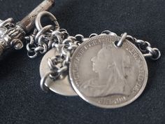 Silver bracelet (stamped 800) with decorative silver plated watch key and two very worn Victorian silver coins. Measures approx 18.5 cm long and weighs 8g. Silver Coin-shaped Engraved Bracelets, Vintage Coin-shaped Engraved Bracelets, Vintage Silver Coin Bracelets, Vintage Silver Coin Bracelet, Silver Charm Bracelet, Silver Coins, Charm Bracelets, Silver Charms, Silver Plate