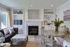 a living room filled with furniture and a fire place