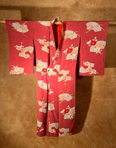 "It is an antique silk kinsha kimono. The color is darker pink and crimson than red. It is very soft to the touch. A variety of flowers are scattered throughout and it is a design unique to antiques. It is a very lovely kimono. The overall condition is good, there is a little color unevenness around the front left hem, back middle, and front right sleeve, but it is not very noticeable.  Most of our Kimonos and Haoris are hand sewn and custom made. We measure from sleeve edge- to-edge (horizontal Pink Silk Kimono For Wedding, Pink Silk Wedding Kimono, Red Vintage Kimono For Spring, Pink Silk Long Sleeve Kimono, Vintage Red Kimono For Tea Ceremony, Vintage Red Long Kimono, Vintage Long Red Kimono, Traditional Pink Kimono For Spring, Vintage Red Kimono For Wedding