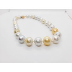 Beautiful estate necklace showcasing 27 white and yellow South Sea pearls and 0.50 ct. of white diamond rounds in a 18k yellow gold clasp.  Superb luster and minimal to no blemishes. The alternating white and yellow pearls make this classic necklace unique and fun.  Mint condition.  Metal: 18k Gold Stone: Diamond,South Sea Pearl Stone Cut: Round Cut  Dimensions for the item are unknown. Please reach out in the seller Q&A with questions White High Luster Round Bead Necklaces, White High Luster Round Beaded Necklaces, Elegant Yellow Necklace With High Luster, White High Luster Pearl Necklaces, White High Luster Round Beads Necklace, White Akoya Pearl Necklace With High Luster, Elegant Yellow High Luster Necklace, Elegant Yellow Pearl Necklaces, Elegant Yellow Pearl Necklace