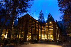 a large building lit up at night in the woods