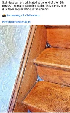 an old wooden stair case sitting on top of a carpeted floor next to a wall