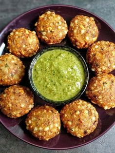 a purple plate topped with meat patties and green sauce