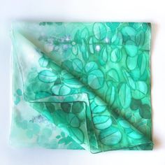 Jade silk scarf, hand paint with silk paint in green and turquoise shades on white. Size: 61 by 17 inches Silk: pure Habotai Light, semi transparent and a bit glossy This long, light scarf is ready to be shipped! It is hand painted with special silk paints that can be washed (for silk sake, please wash by hand! I am attaching an easy-to-follow instruction). The scarf won't fade! On this white and green silk wrap I have painted jade plant (you know it? Super popular indoor Crassula plant that bri Green Bohemian Silk Scarf For Gift, Green Bohemian Silk Scarf As Gift, Bohemian Green Silk Scarf As Gift, Green Hand Dyed Bohemian Scarf, Green Silk Scarves For Summer, Green Silk Bohemian Scarves, Bohemian Green Silk Scarves, Artistic Hand Dyed Green Silk Scarf, Artistic Green Silk Scarf As A Gift