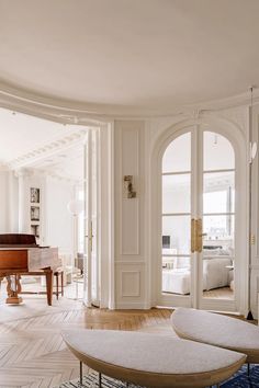 a living room filled with furniture and a grand piano