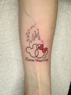 a person with a tattoo on their leg that says, choose happiness and mickey mouse