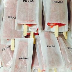 there are many bags that have popsicles stuck to them with the words prada on them